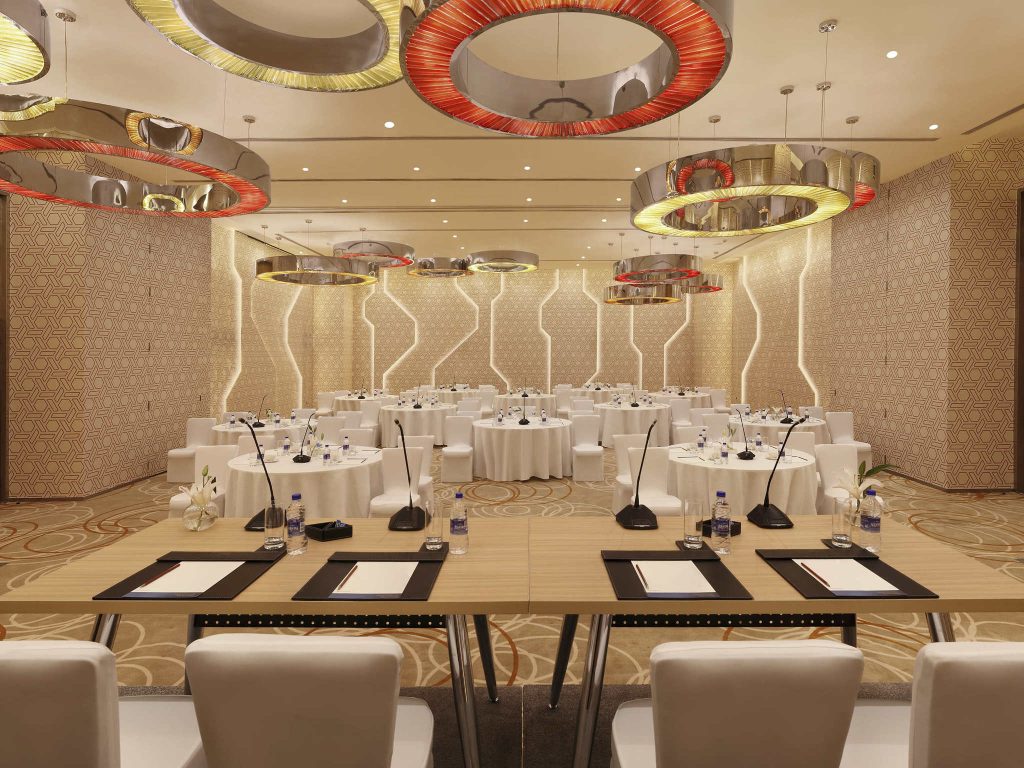 banquet hall with white chairs with round tables